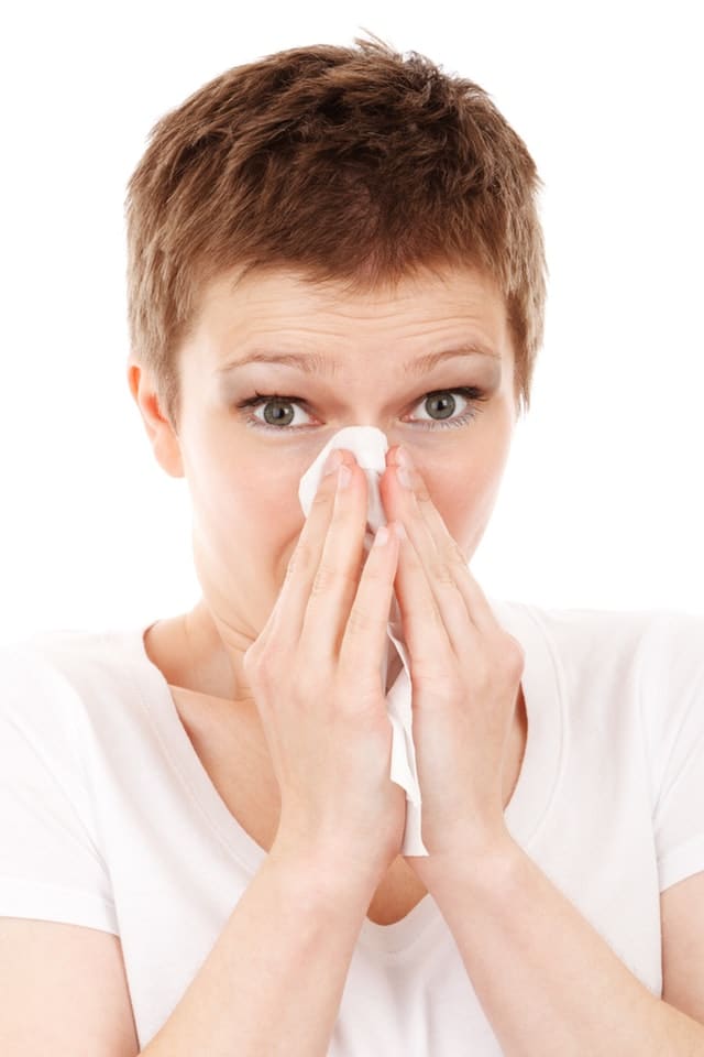 Woman blowing her nose with tissue - Las Vegas