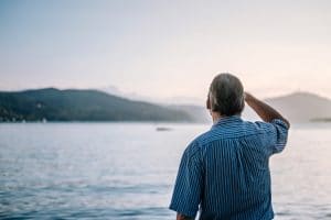 Man looks out at lake.