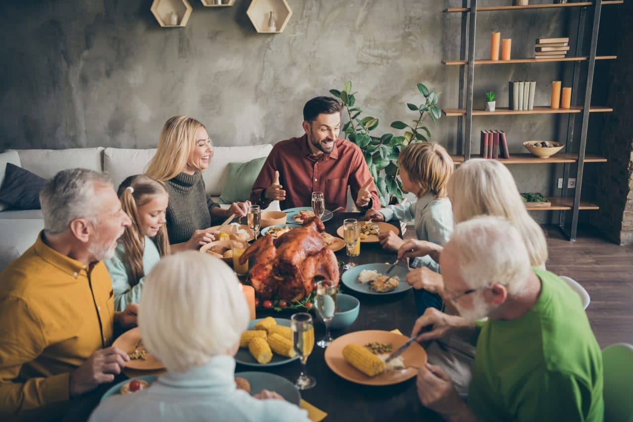 A large family enjoying dinner for the holidays.