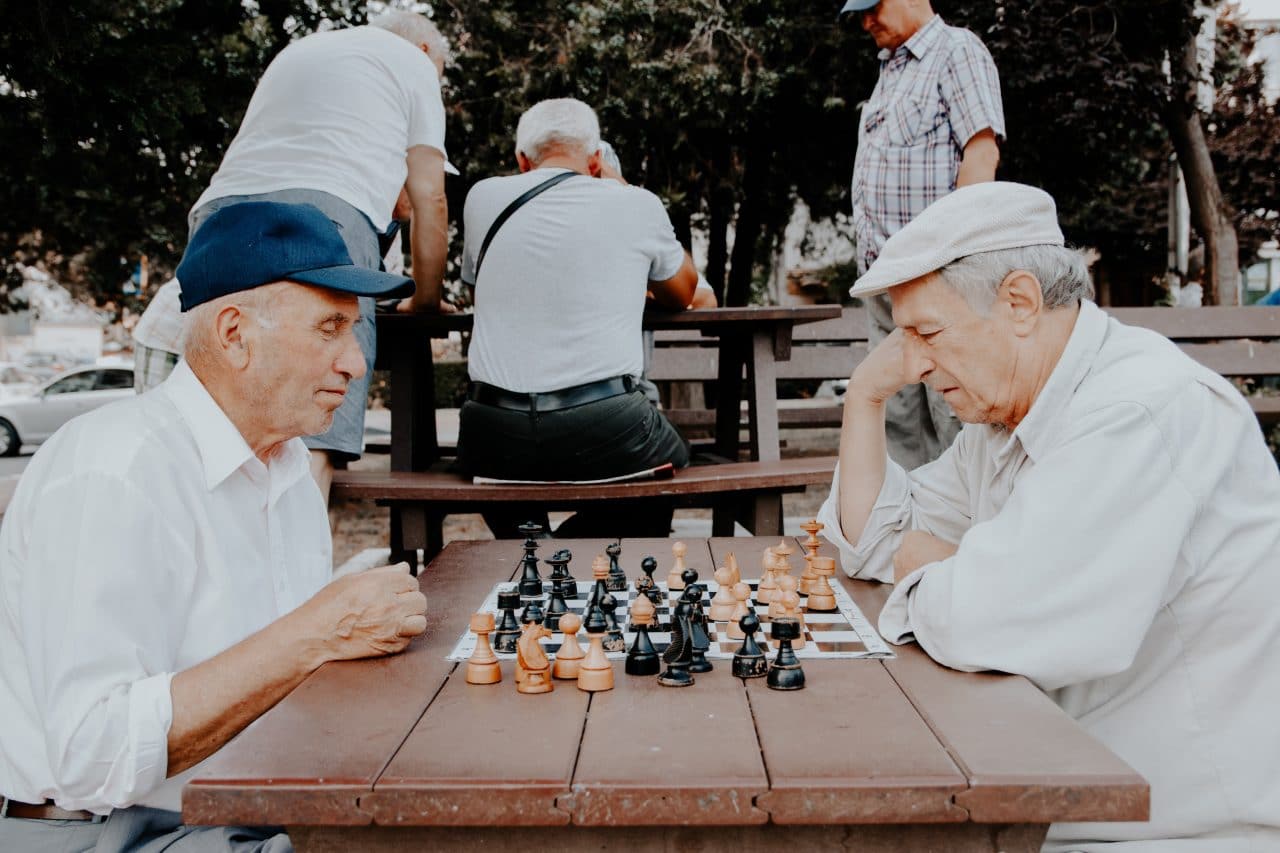 Two older men playing chess.