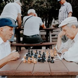 Two older men playing chess.