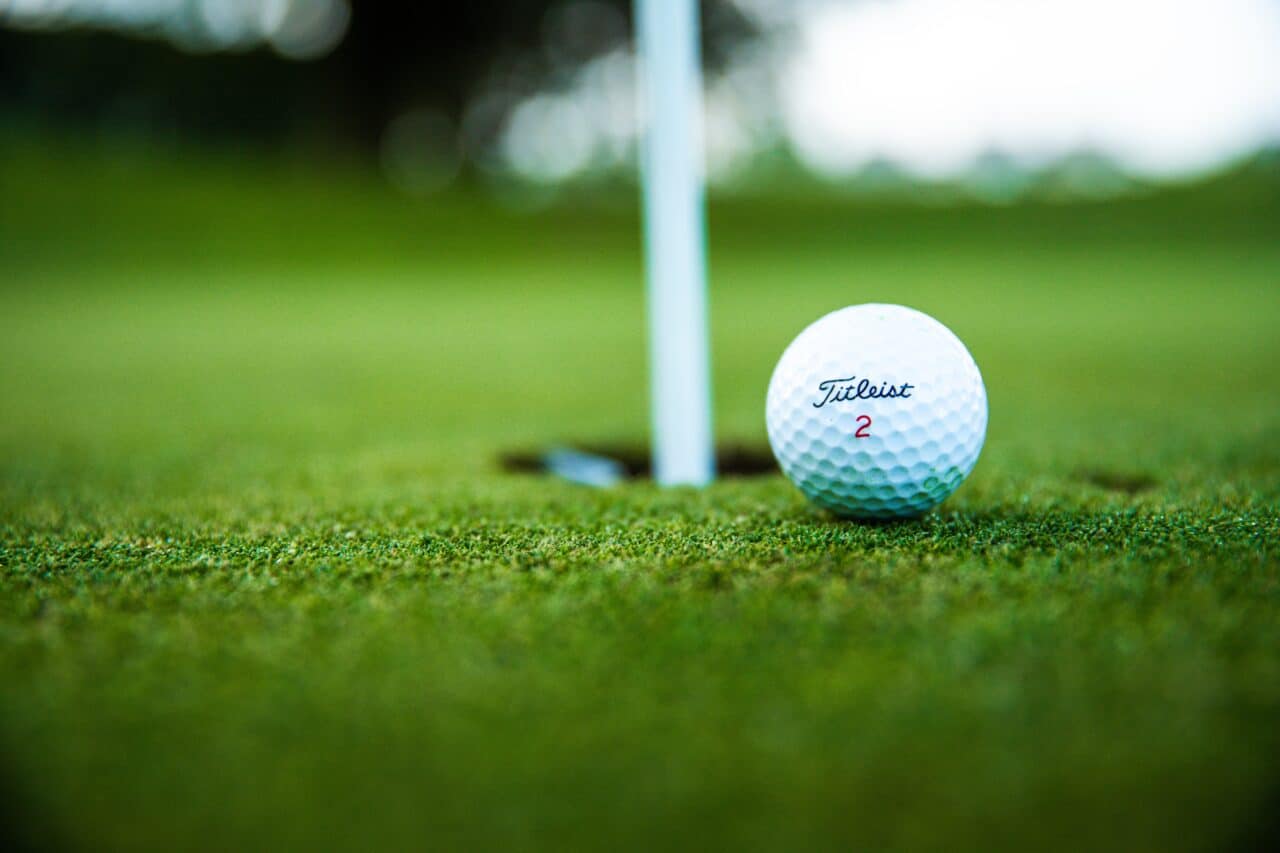Close-up of a golf ball on a putting green.