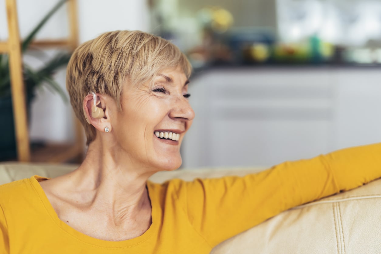 Happy woman with hearing aids.